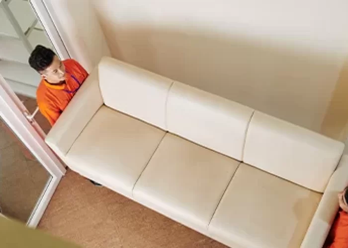 a person standing behind a couch
